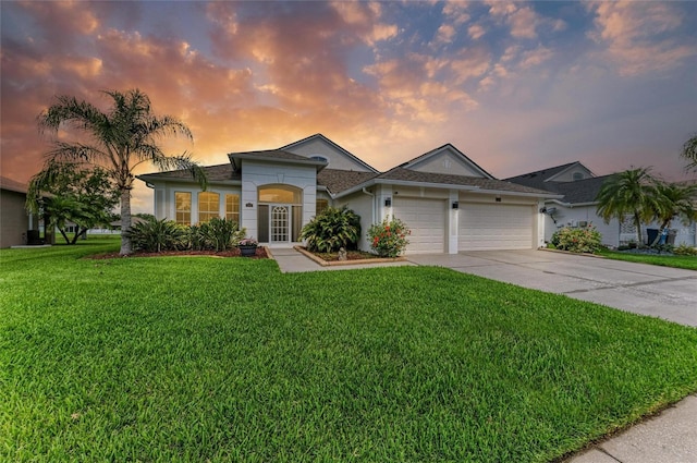 5319 120th Ave E, Parrish, FL 34219 - ranch-style home with a garage, concrete driveway, a yard, and stucco siding