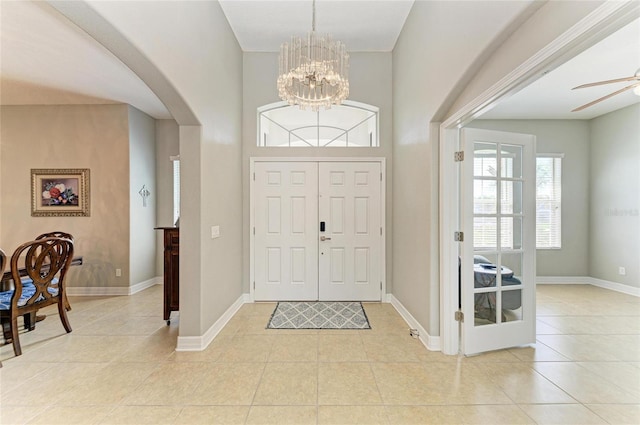 5319 120th Ave E, Parrish, FL 34219 - foyer entrance featuring light tile patterned floors, arched walkways, a chandelier, and baseboards