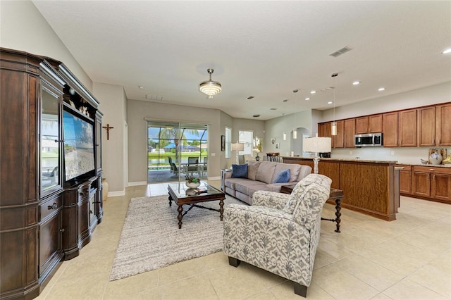 5319 120th Ave E, Parrish, FL 34219 - living area with recessed lighting, light tile patterned floors, arched walkways, and baseboards