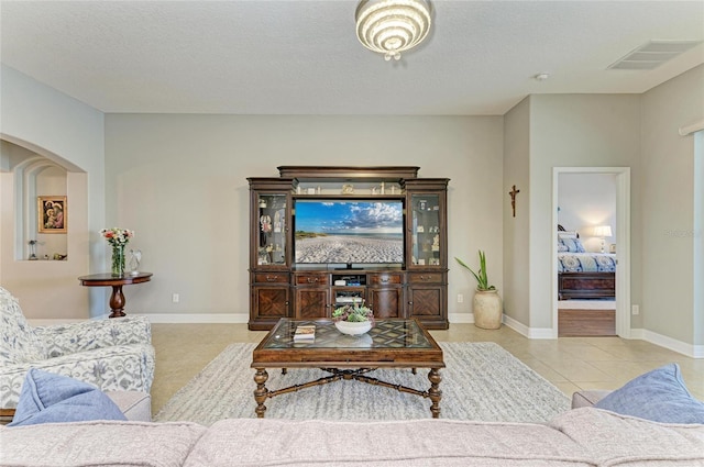 5319 120th Ave E, Parrish, FL 34219 - living area with light tile patterned floors, arched walkways, and baseboards