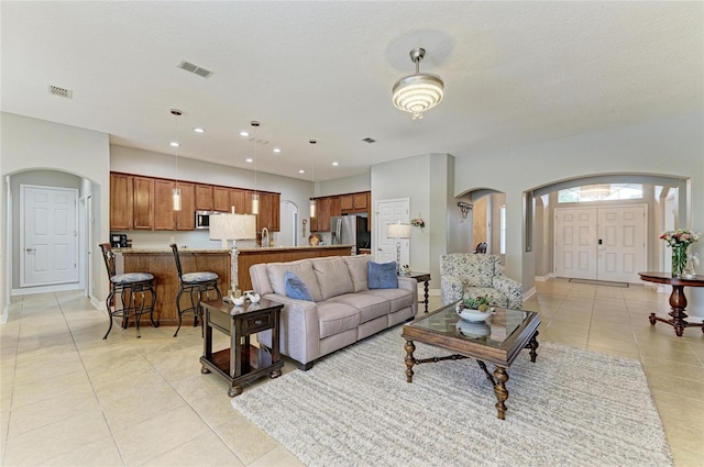 5319 120th Ave E, Parrish, FL 34219 - living area featuring arched walkways, light tile patterned floors, baseboards, and recessed lighting