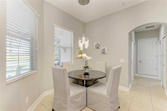 5319 120th Ave E, Parrish, FL 34219 - dining area featuring arched walkways, light tile patterned floors, baseboards, and a chandelier