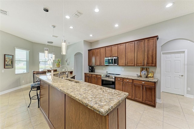 5319 120th Ave E, Parrish, FL 34219 - kitchen featuring stainless steel appliances, arched walkways, a sink, recessed lighting, and light tile patterned flooring