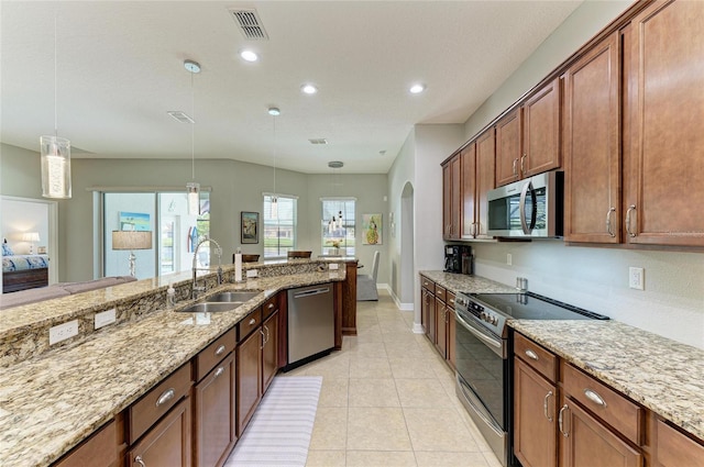 5319 120th Ave E, Parrish, FL 34219 - kitchen featuring appliances with stainless steel finishes, a sink, pendant lighting, recessed lighting, and light stone countertops