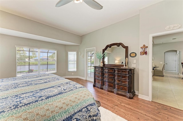 5319 120th Ave E, Parrish, FL 34219 - bedroom with arched walkways, wood finished floors, baseboards, and a ceiling fan