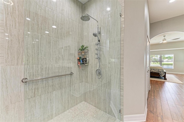 5319 120th Ave E, Parrish, FL 34219 - bathroom with tiled shower, ensuite bath, wood finished floors, baseboards, and a ceiling fan