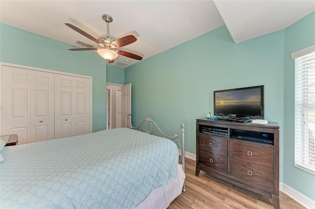 5319 120th Ave E, Parrish, FL 34219 - bedroom with a closet, light wood finished floors, multiple windows, baseboards, and lofted ceiling