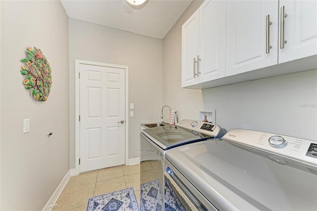 5319 120th Ave E, Parrish, FL 34219 - washroom featuring cabinet space, washer and clothes dryer, baseboards, and light tile patterned floors