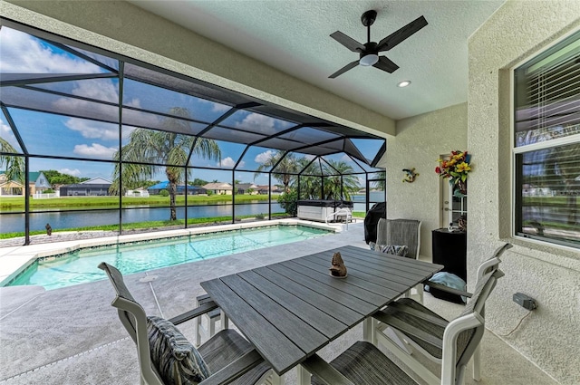 5319 120th Ave E, Parrish, FL 34219 - view of patio featuring a water view, a ceiling fan, a hot tub, outdoor dining area, and an outdoor pool