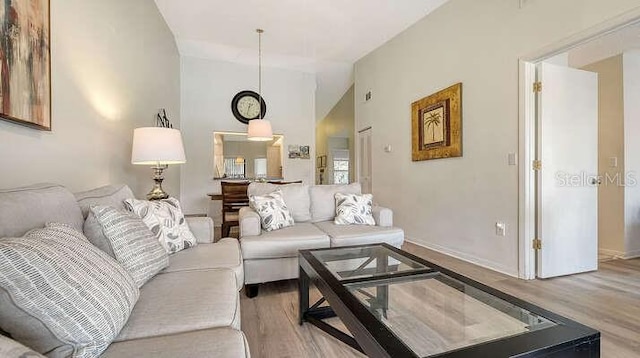 4325 46th Ave W Unit 203, Bradenton, FL 34210 - living room with wood finished floors, lofted ceiling, and baseboards