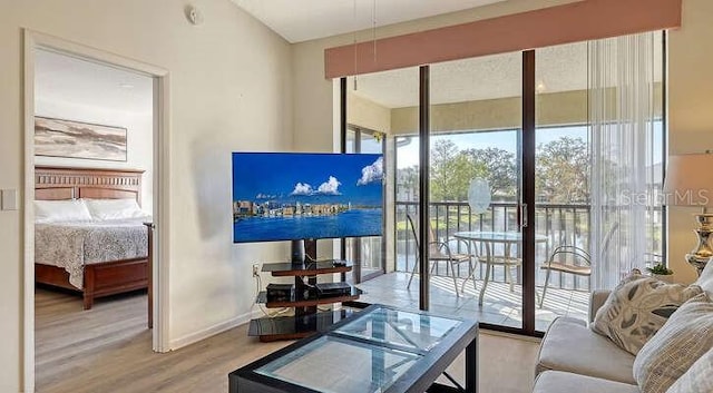 4325 46th Ave W Unit 203, Bradenton, FL 34210 - living area with healthy amount of natural light, wood finished floors, and baseboards