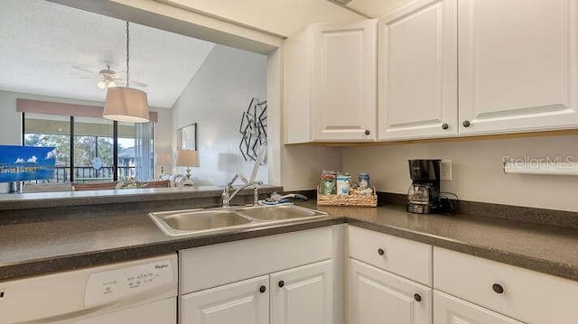 4325 46th Ave W Unit 203, Bradenton, FL 34210 - kitchen with white dishwasher, a sink, dark countertops, and white cabinets