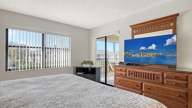 4325 46th Ave W Unit 203, Bradenton, FL 34210 - bedroom with a textured ceiling and access to outside