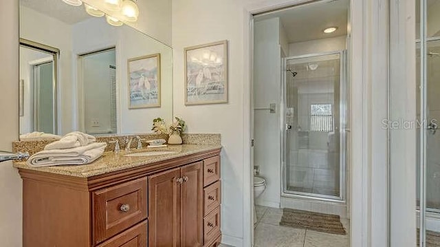 4325 46th Ave W Unit 203, Bradenton, FL 34210 - bathroom with toilet, vanity, a stall shower, and tile patterned flooring