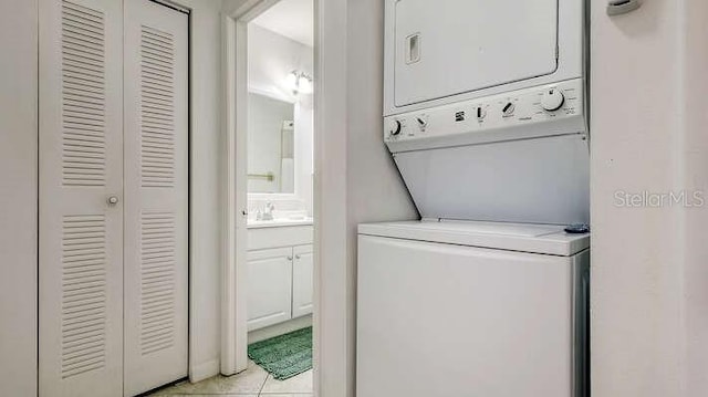 4325 46th Ave W Unit 203, Bradenton, FL 34210 - washroom with estacked washer and dryer and light tile patterned flooring