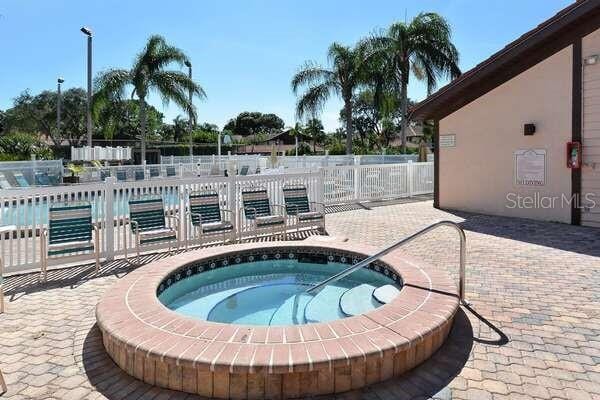 4325 46th Ave W Unit 203, Bradenton, FL 34210 - view of swimming pool featuring a community hot tub, a patio, and a swimming pool