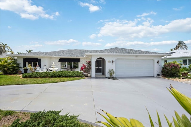 965 E Gondola Dr, Venice, FL 34293 - ranch-style home with stucco siding, an attached garage, and driveway