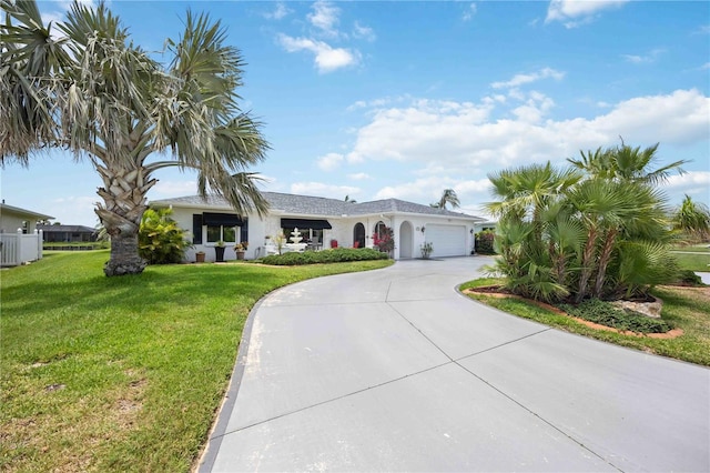 965 E Gondola Dr, Venice, FL 34293 - single story home featuring an attached garage, curved driveway, a front lawn, and stucco siding