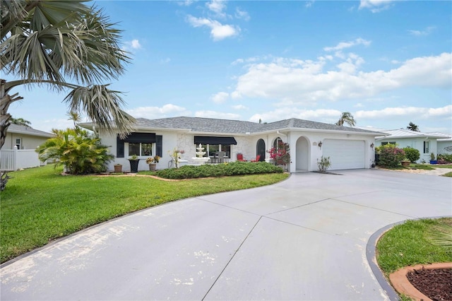 965 E Gondola Dr, Venice, FL 34293 - single story home with stucco siding, a garage, concrete driveway, and a front yard