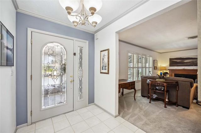 965 E Gondola Dr, Venice, FL 34293 - foyer entrance featuring ornamental molding, a chandelier, a fireplace, baseboards, and light carpet