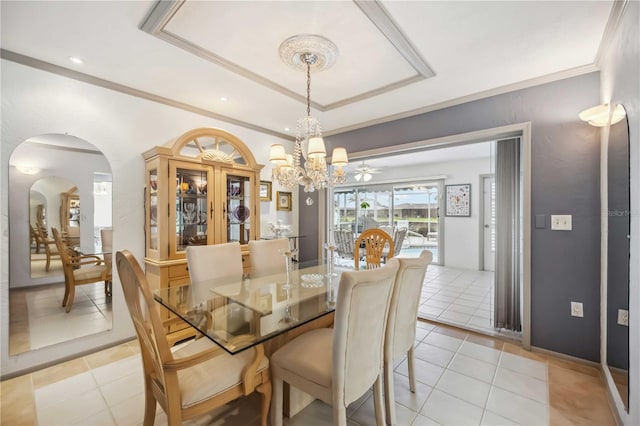 965 E Gondola Dr, Venice, FL 34293 - dining room featuring light tile patterned floors, a chandelier, arched walkways, a tray ceiling, and ornamental molding