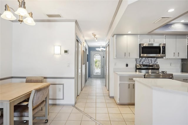 965 E Gondola Dr, Venice, FL 34293 - kitchen featuring stainless steel appliances, a chandelier, light countertops, light tile patterned floors, and recessed lighting