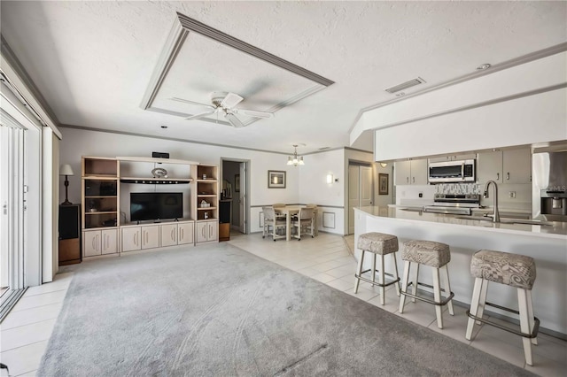 965 E Gondola Dr, Venice, FL 34293 - living area featuring light tile patterned floors, a textured ceiling, a ceiling fan, a chandelier, and ornamental molding