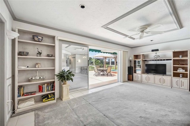965 E Gondola Dr, Venice, FL 34293 - living room featuring ceiling fan, tile patterned floors, built in shelves, a textured ceiling, and carpet floors