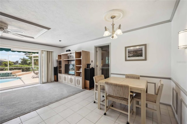 965 E Gondola Dr, Venice, FL 34293 - dining space with light carpet, light tile patterned floors, a chandelier, crown molding, and a ceiling fan