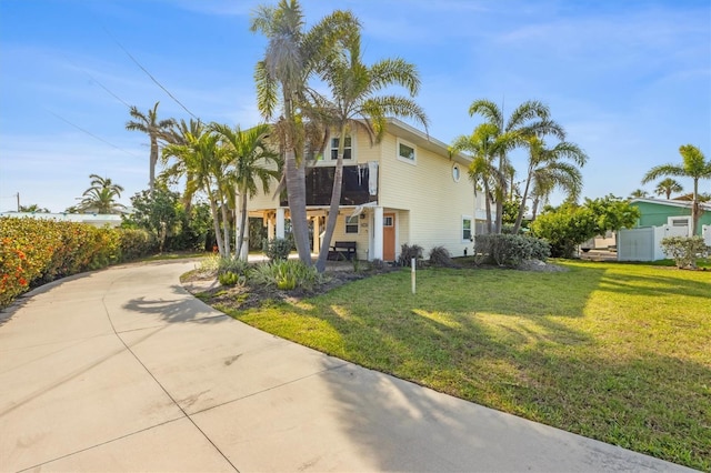221 85th St, Holmes Beach, FL 34217 - view of front of home featuring a front yard and driveway