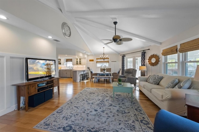 221 85th St, Holmes Beach, FL 34217 - living area featuring ceiling fan, light wood-style flooring, and a chandelier