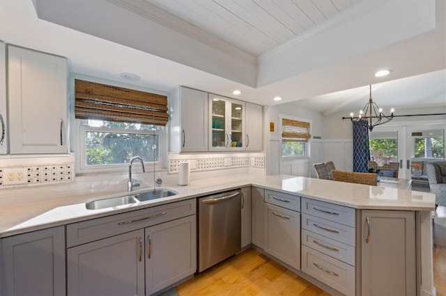 221 85th St, Holmes Beach, FL 34217 - kitchen featuring stainless steel dishwasher, a sink, gray cabinets, a peninsula, and crown molding