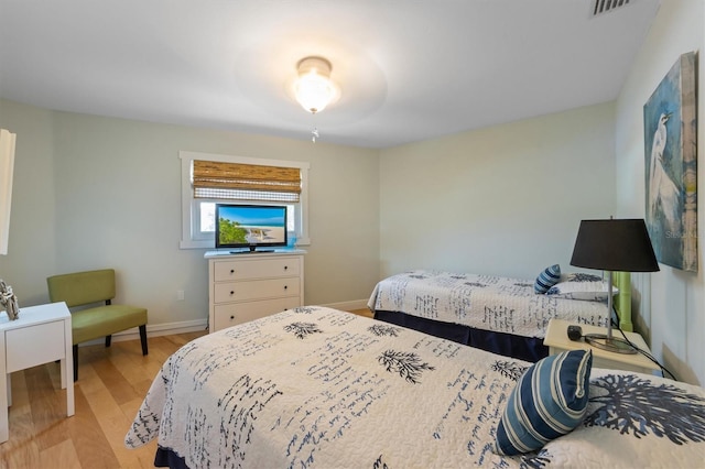 221 85th St, Holmes Beach, FL 34217 - bedroom featuring light wood-type flooring and baseboards