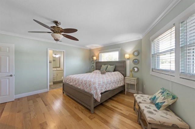 221 85th St, Holmes Beach, FL 34217 - bedroom with light wood-type flooring, crown molding, baseboards, a ceiling fan, and connected bathroom