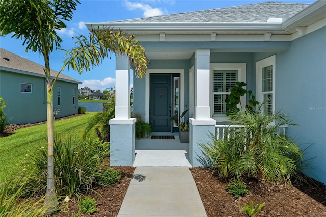 4407 Big Woods Way, Parrish, FL 34219 - property entrance featuring covered porch, stucco siding, roof with shingles, and a yard