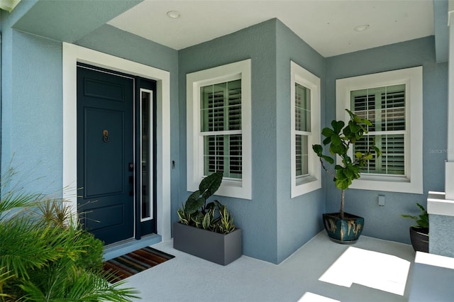 4407 Big Woods Way, Parrish, FL 34219 - view of exterior entry featuring stucco siding and a porch