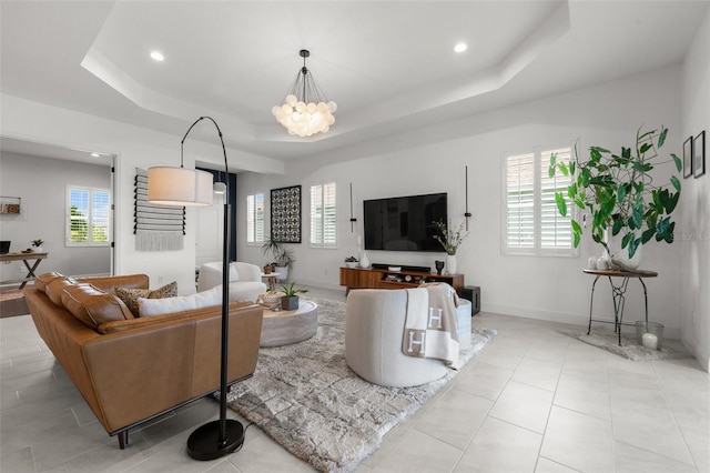 4407 Big Woods Way, Parrish, FL 34219 - living area featuring a tray ceiling, healthy amount of natural light, recessed lighting, a chandelier, and baseboards
