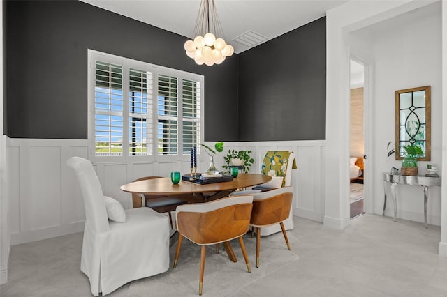 4407 Big Woods Way, Parrish, FL 34219 - dining room with a decorative wall, a wainscoted wall, and a chandelier