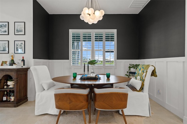 4407 Big Woods Way, Parrish, FL 34219 - dining area with light tile patterned floors, a decorative wall, a chandelier, and wainscoting