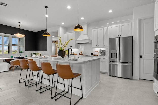 4407 Big Woods Way, Parrish, FL 34219 - kitchen with appliances with stainless steel finishes, light countertops, custom exhaust hood, a breakfast bar area, and recessed lighting
