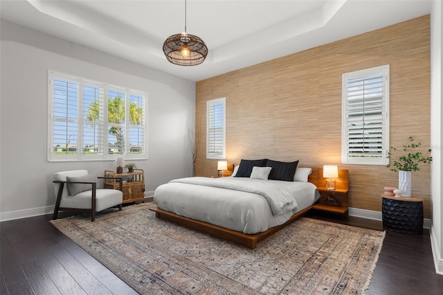 4407 Big Woods Way, Parrish, FL 34219 - bedroom featuring baseboards, a raised ceiling, wood finished floors, and an accent wall