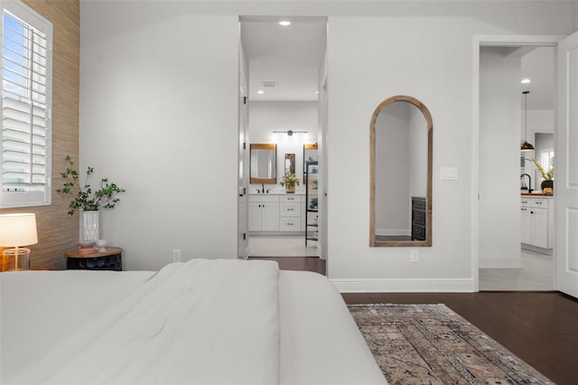 4407 Big Woods Way, Parrish, FL 34219 - bedroom with wood finished floors, ensuite bath, baseboards, and recessed lighting