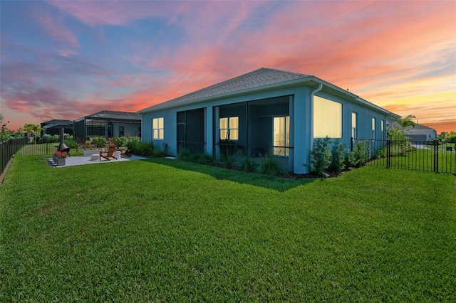 4407 Big Woods Way, Parrish, FL 34219 - back of house at dusk featuring a patio area, stucco siding, and a sunroom
