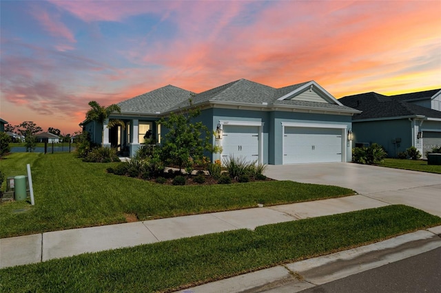 4407 Big Woods Way, Parrish, FL 34219 - ranch-style home featuring a garage, driveway, a lawn, stucco siding, and a shingled roof
