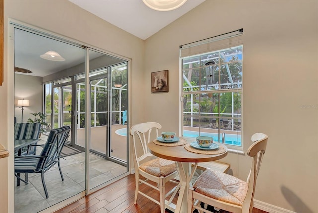 4322 Concert St, Port Charlotte, FL 33948 - dining area featuring light wood-type flooring, lofted ceiling, and baseboards