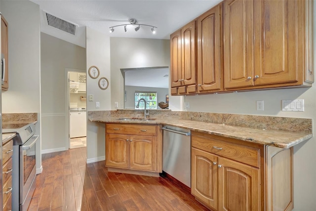 4322 Concert St, Port Charlotte, FL 33948 - kitchen with appliances with stainless steel finishes, a sink, dark wood-type flooring, light stone countertops, and baseboards