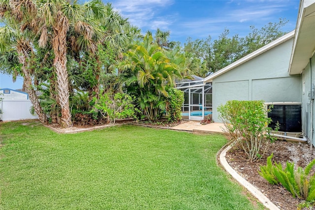 4322 Concert St, Port Charlotte, FL 33948 - view of green lawn with a lanai, cooling unit, and a patio