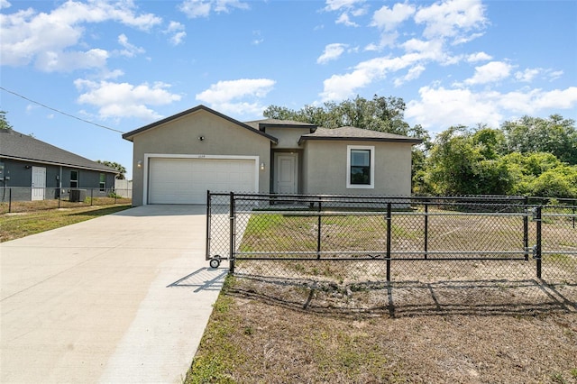 1229 Zinnia Loop, Labelle, FL 33935 - ranch-style home with stucco siding, an attached garage, concrete driveway, and a gate