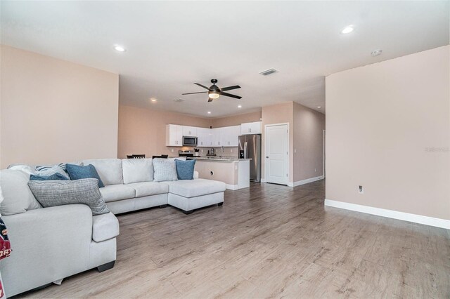 1229 Zinnia Loop, Labelle, FL 33935 - living area with light wood-type flooring, recessed lighting, a ceiling fan, and baseboards