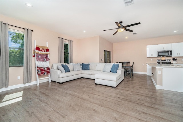 1229 Zinnia Loop, Labelle, FL 33935 - living area with light wood finished floors, baseboards, recessed lighting, and ceiling fan